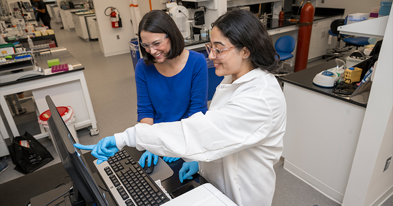 Day (left) working in her lab at the Ammon Pinizzotto Biopharmaceutical Innovation Center with doctoral student Maneesha Sahni. 