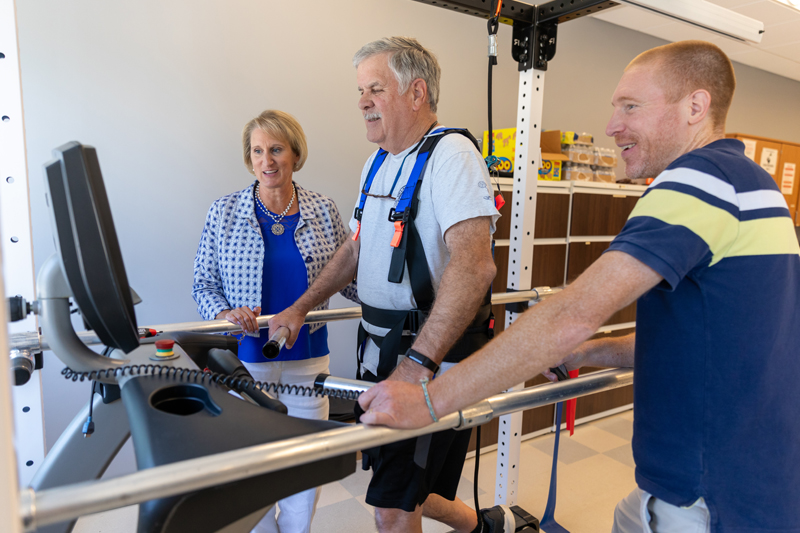 Stroke survivor Larry Christian pictured with research assistant Henry Wright and professor Darcy Reisman.