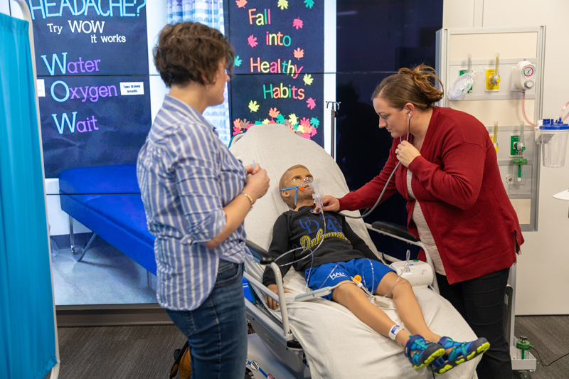 School nurses take part in a simulation on asthma exacerbation so they can sharpen their skills and be prepared for emergencies they face on the job