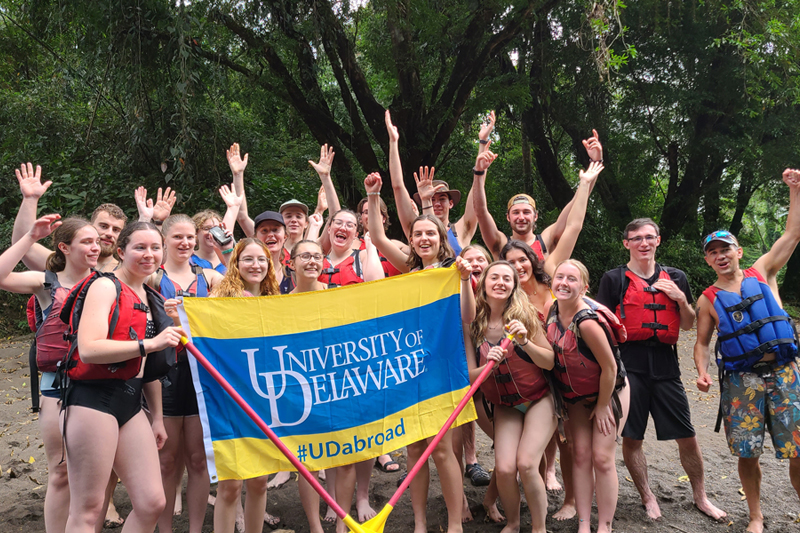 UD students and Kyle McCarthy, associate professor of wildlife ecology, pose for a group photo during a tour of the Sarapiqui River with trained bird guides.