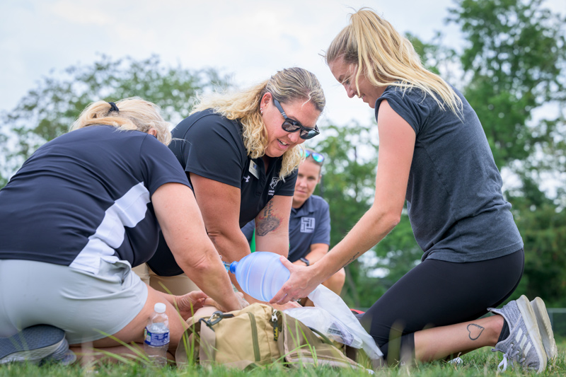 UD and College of Health Science athletic training alumna Heather Heidel, who is the lead athletic trainer at Sussex Technical High School, practices CPR with fellow athletic trainers.  