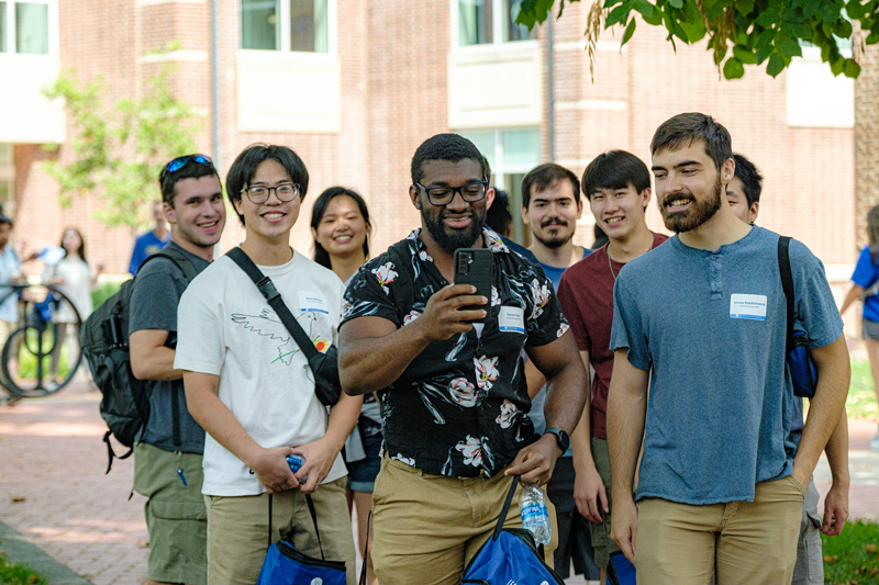 New Blue Hen graduate students pose for a selfie in front of the Carpenter Sports Building during New Graduate Student Orientation. New Blue Hen graduate students pose for a selfie in front of the Carpenter Sports Building during New Graduate Student Orientation.
