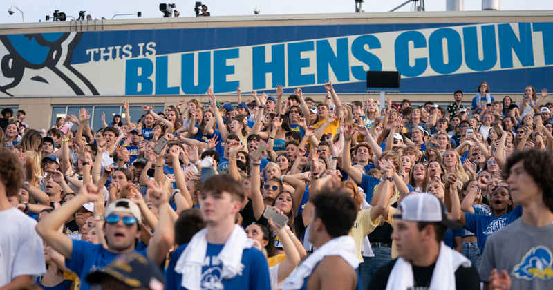 students at a Delaware football game students at a Delaware football game
