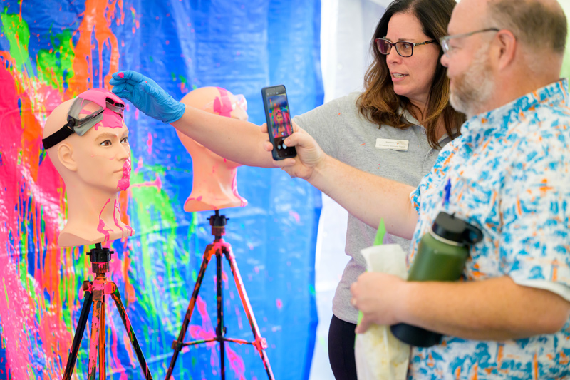 Interactive demonstrations like paint throwing helped participants in the Ammon Pinizzotto Biopharmaceutical Center safety retreat held on Sept. 20 understand first-hand the protective capabilities of gear like safety glasses in an emergency.