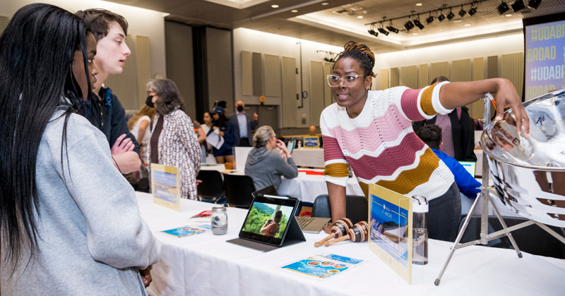 Josanne Francis spoke with interested students about the annual Music/History program in Trinidad and Tobago at the spring Study Abroad Fair. Josanne Francis spoke with interested students about the annual Music/History program in Trinidad and Tobago at the spring Study Abroad Fair.
