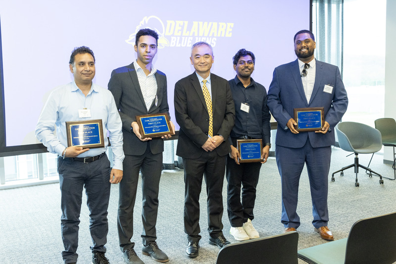 The Analytical Artisans pose with Lerner Dean Oliver Yao. 