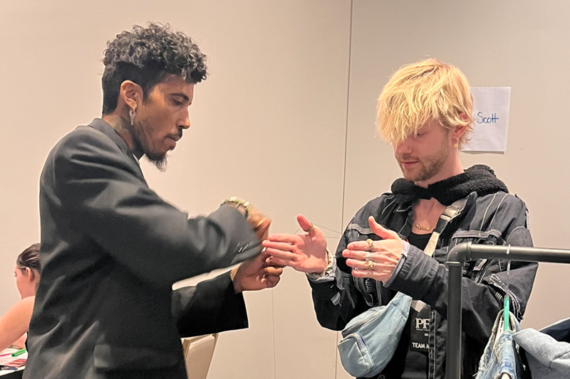 Casey Tyler (right) assists designer Orlando Montanez with the brand Parallel's collection during Philly Fashion Week. Tyler volunteered for the designer during the event. 