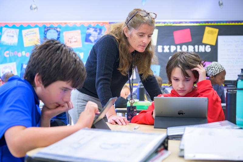 Laurie Drumm, master teacher and technology coordinator at The College School, guides sixth graders Joey and Morgan as they complete a lesson on a tablet. 