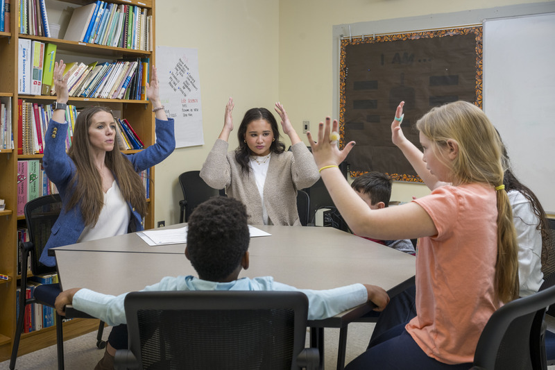 Brittany Zakszeski, assistant professor in UD's College of Education and Human Development (CEHD), teaches elementary school students body-centered relaxation techniques with Allison Reed, a graduate student in CEHD's school psychology program, at CEHD’s The College School.
