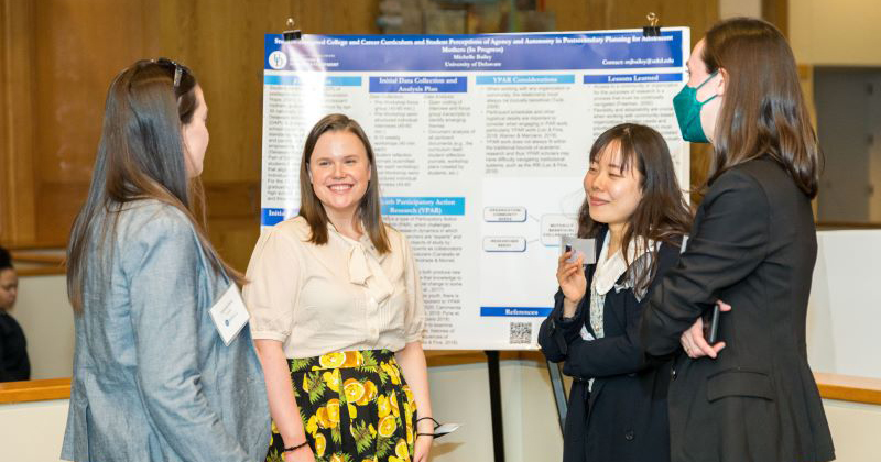 Attendees at CEHD's Steele Symposium discuss student research during the event's poster session.