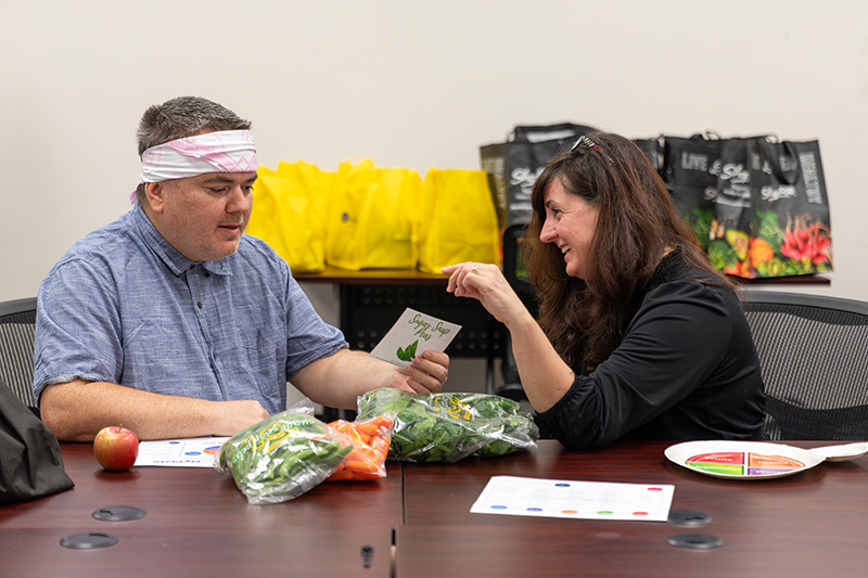 Donna Paulhamus, Nutrition Clinic director, talks with Brian Colhouer about ways to add sugar snap peas to his diet as part of a fruit and produce prescription program being piloted at Horizon House in Wilmington. Donna Paulhamus, Nutrition Clinic director, talks with Brian Colhouer about ways to add sugar snap peas to his diet as part of a fruit and produce prescription program being piloted at Horizon House in Wilmington.