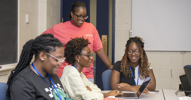 Nafatari Manigault, the academic coordinator for the Upward Bound program, overlooks the work of participants during class. Nafatari Manigault, the academic coordinator for the Upward Bound program, overlooks the work of participants during class.