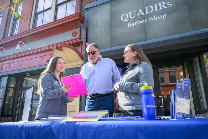 Olivia Dallas (left) and Faith Stagge (right), communication sciences and disorders doctoral students, set up shop outside Quadir’s Barber Shop in Wilmington as part of a novel, community-based strategy to recruit diverse study participants. Olivia Dallas (left) and Faith Stagge (right), communication sciences and disorders doctoral students, set up shop outside Quadir’s Barber Shop in Wilmington as part of a novel, community-based strategy to recruit diverse study participants.
