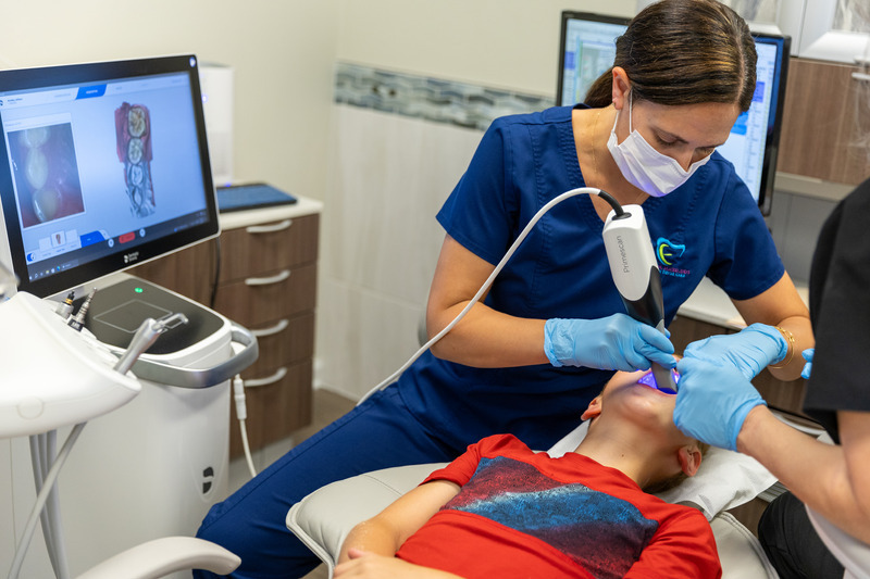 Newark dentist and UD alumna Dr. Erin Macko performs intra-oral scans on youth soccer players to assist in the creation of custom-fitted mouthpieces to be worn by participants in Thomas Kaminski’s U.S. Soccer-funded study. Newark dentist and UD alumna Dr. Erin Macko performs intra-oral scans on youth soccer players to assist in the creation of custom-fitted mouthpieces to be worn by participants in Thomas Kaminski’s U.S. Soccer-funded study.