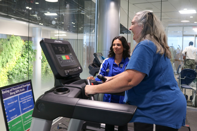 Michelle Babiarz, who has multiple sclerosis, works out with clinical exercise physiologists twice a week at the Exercise and Functional Training Lab on the second floor of the STAR Tower, where exercise physiology graduate students like Robin Collura also get clinical experience.