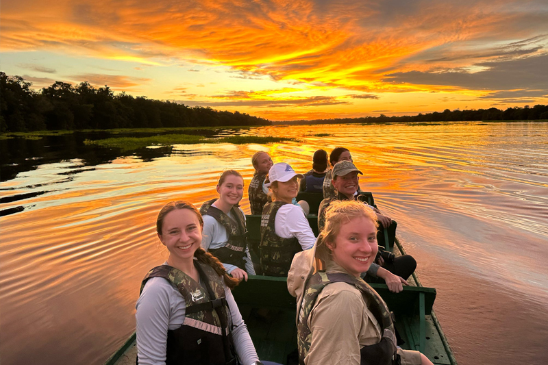 Students viewed the sunset from a canoe on the Amazon as part of a wildlife and sunset boat excursion.