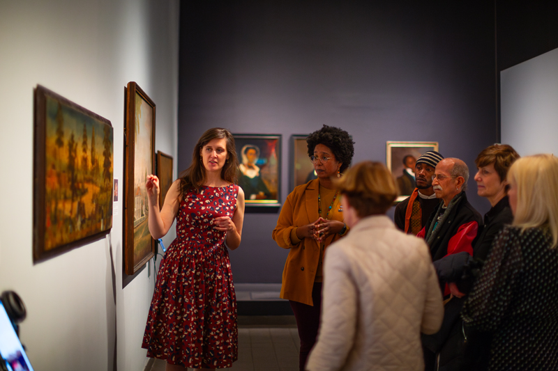 Emelie Gevalt, a UD doctoral student, describes details of a painting in the exhibit during a gallery talk at the American Folk Art Museum.