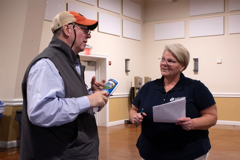 Georgie Cartzana, extension poultry agent, and Tom Boyd, Arkion Life Sciences, discuss a new product coming out to control darkling beetles. 