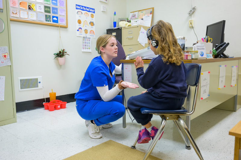Lexie Maxwell, a graduate student in UD’s Speech-Language Pathology program, makes hearing screenings fun for kids. She tells them to give her a high-five when they hear a beep.