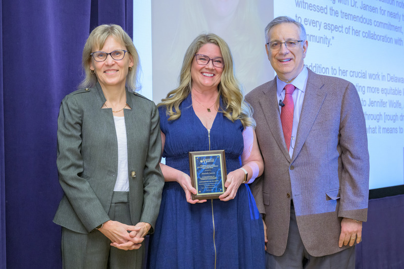 Professor Amanda Jansen, pictured with Provost Laura Carlson and President Dennis Assanis, received the fall 2023 Excellence in Scholarly Community Engagement Award.