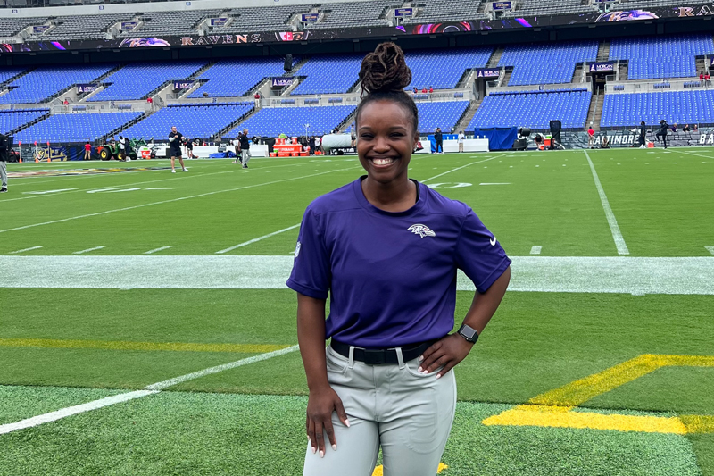 Asha Rogers poses in M&T Bank Stadium, home of the Baltimore Ravens. She completed a full-time clinical rotation with the team before graduating from UDPT.