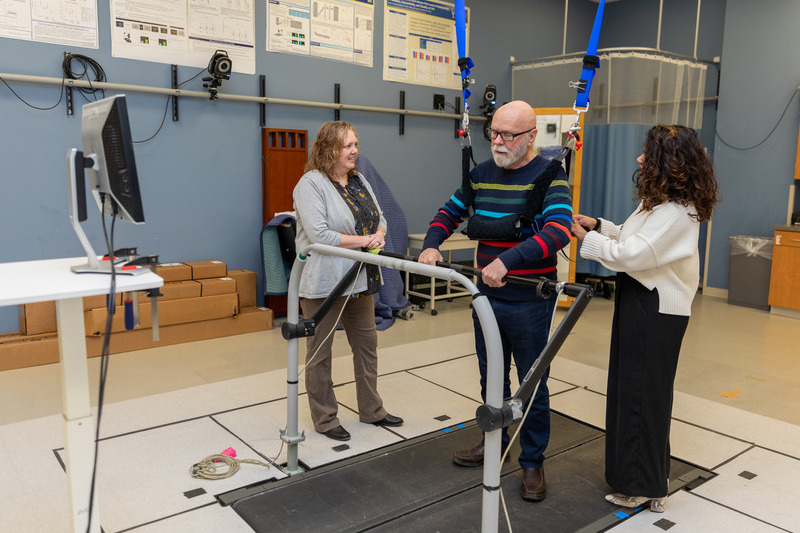 Jim Bowman, a participant in a College of Health Sciences study on motor learning in older adults with mild cognitive impairment, walks on a split-belt treadmill in the Neuromotor Behavior Lab on STAR Campus.