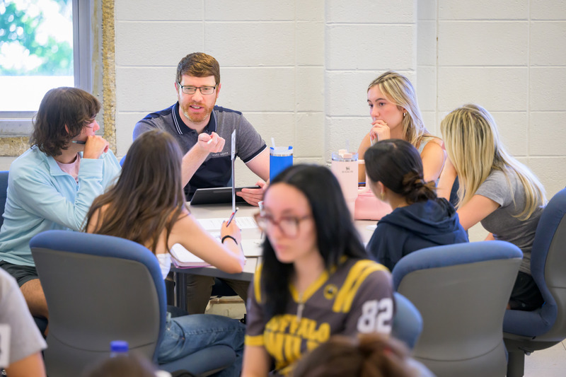 Sam Waters, assistant professor of mathematical sciences, engages with his Pre-Calculus students on day one of his teaching career. Sam Waters, assistant professor of mathematical sciences, engages with his Pre-Calculus students on day one of his teaching career.