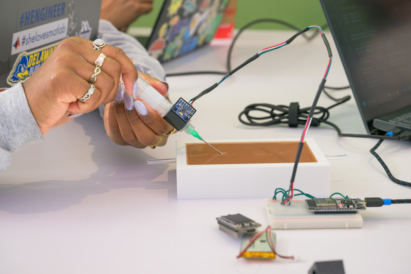 The student team developed a training platform that includes a needle equipped with sensors that register how close the needle came to a “vein” represented by a copper wire embedded in a silicone skin model. The student team developed a training platform that includes a needle equipped with sensors that register how close the needle came to a “vein” represented by a copper wire embedded in a silicone skin model.