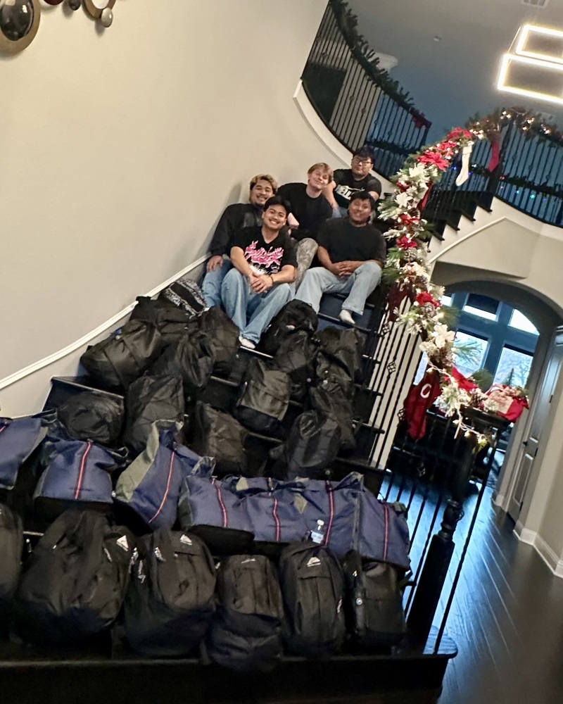 Woelki and his friends John Mualcin, Phun Mualcin, Van Thang and Amos Van Bawi Bik prepare to distribute backpacks to those experiencing housing instability during the 2024 holiday season in Dallas, Texas. 