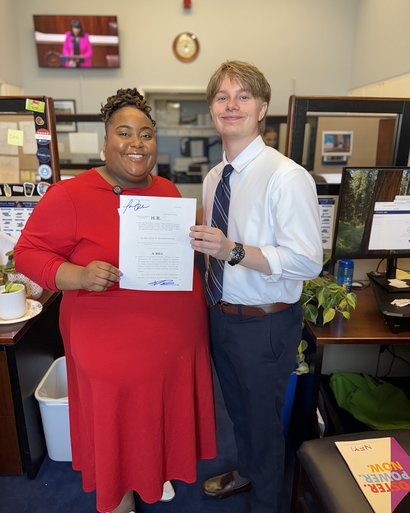Woelki with Tashia Roberson-Wing, senior legislative assistant to Representative Greg Landsman, after signing a copy of the reintroduced Campus Housing Affordability for Foster Youth Act.