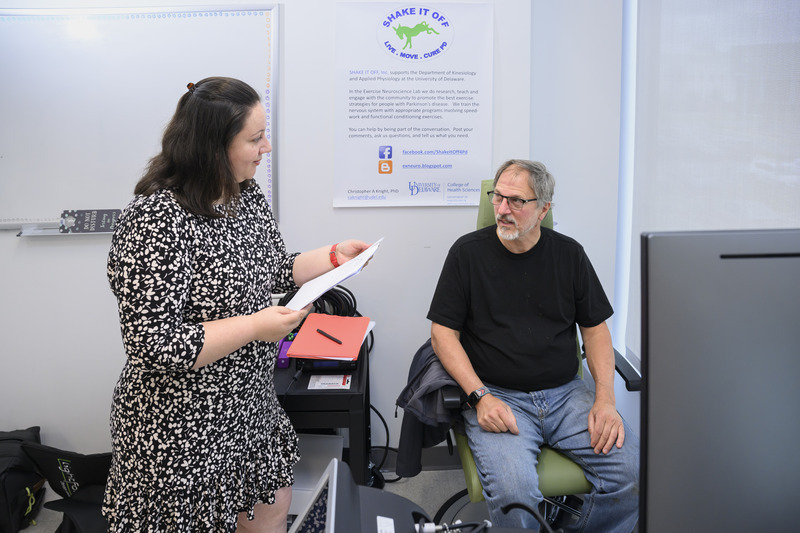 The laser therapy study, supported by UD’s Big Ideas Challenge, is being administered by Roxana Burciu (left), assistant professor of kinesiology and applied physiology, whose research focuses on Parkinson’s disease (PD). Pictured here, Burciu is talking with study participant Tim Hihn (right), who was diagnosed with PD in 2021. The laser therapy study, supported by UD’s Big Ideas Challenge, is being administered by Roxana Burciu (left), assistant professor of kinesiology and applied physiology, whose research focuses on Parkinson’s disease (PD). Pictured here, Burciu is talking with study participant Tim Hihn (right), who was diagnosed with PD in 2021.
