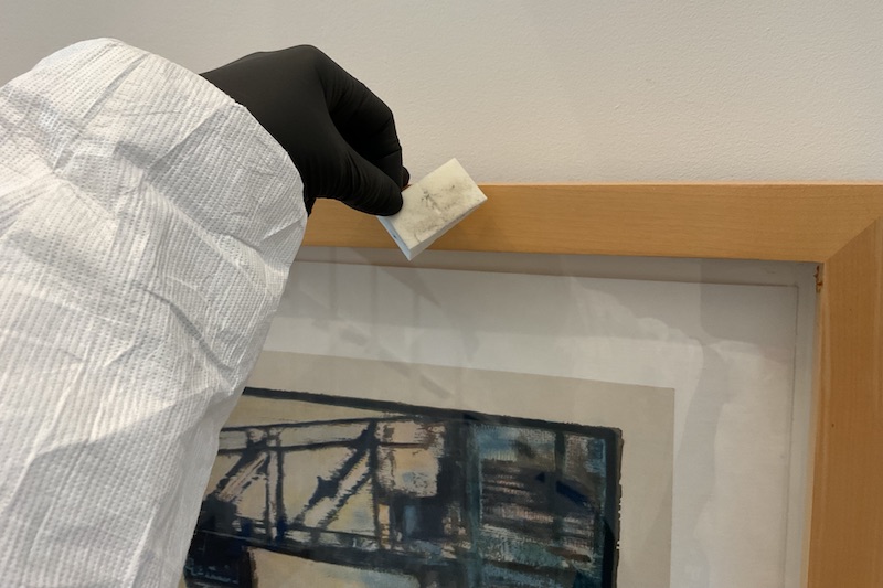 Smoke and water damage are common problems in areas affected by fire. In this photo, Madison Brockman tests a framed item for soot and ash using a white cosmetic sponge. Smoke and water damage are common problems in areas affected by fire. In this photo, Madison Brockman tests a framed item for soot and ash using a white cosmetic sponge.