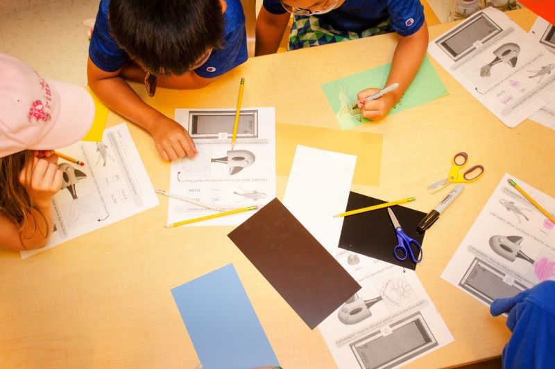 Summer campers at CEHD’s Early Learning Center design tails for their robotic fish. 