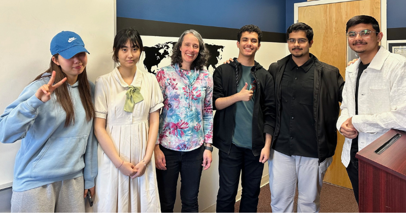 Untitled design - 1 Students smile with their A-UD academic advisor.