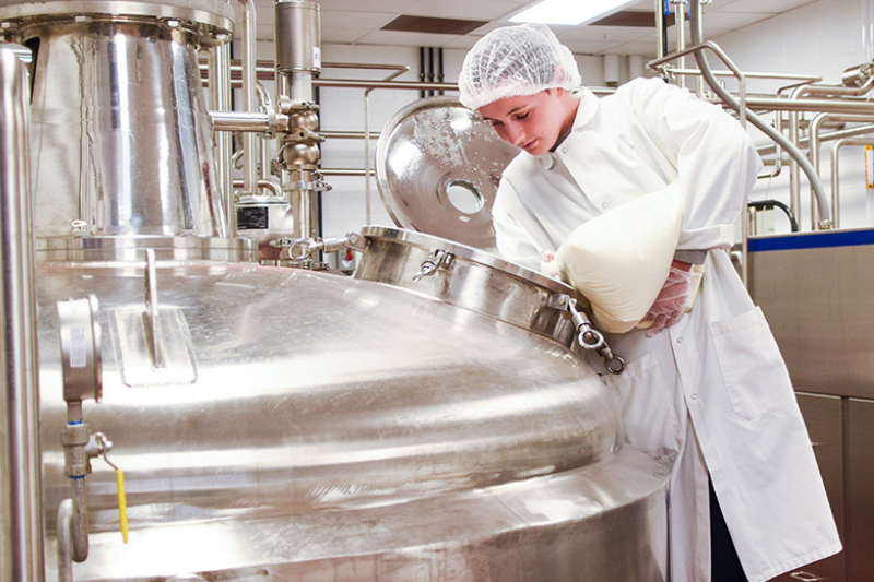Anne Connelly, a senior food science major, works as a dairy production intern at the UDairy Creamery in the Genuardi Food Innovation Laboratory (GFIL). 