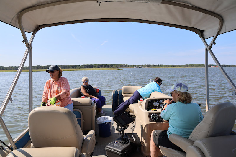 Gail Kelso, Mary Ann Varner, Mickey Nagle and Kathy Ellis look for lost or abandoned crab pots in the Indian River. Kelso said the friends, who are all in their 70s, have a shared goal of keeping the Indian River clean.