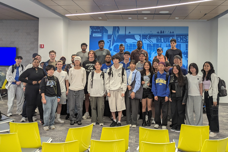 The international students gather with the football players after the panel Q&A.