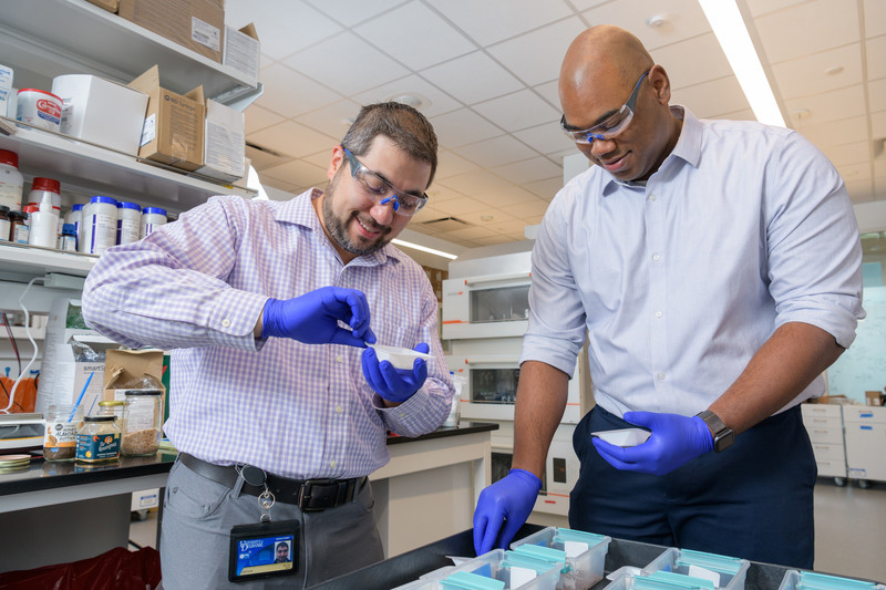 Blenner and Kevin Solomon, both Thomas and Kipp Gutshall Career Development Associate Professors, work together in the laboratory.