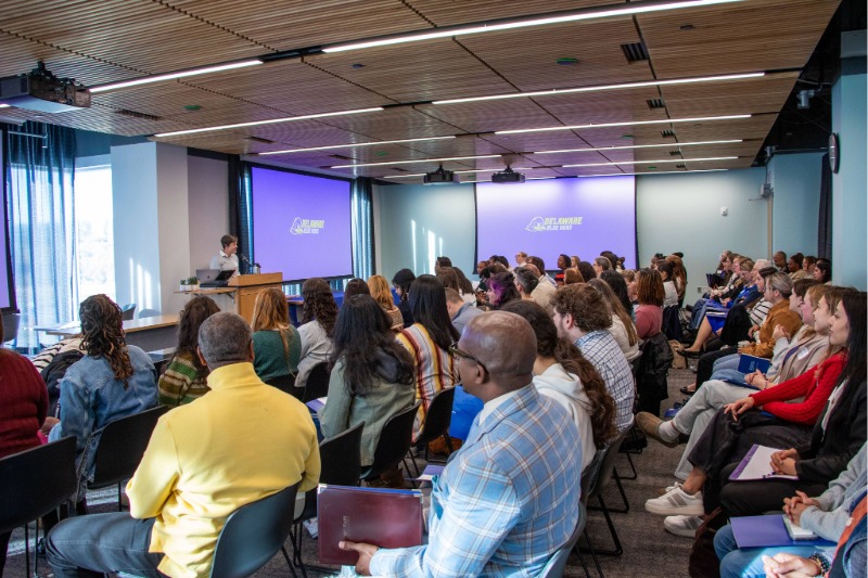 Carly Hill, research associate in the College of Education and Human Development’s (CEHD) Center for Research in Education and Social Policy, introduces Assistant Professor Ohiro Oni-Eseleh and Professor Raphael Travis at the college’s October 2025 social work conference.