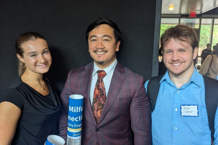Jimmart (Jay) Amamio (center) with Samantha Papili (left) and Ethan Saylor, who were also funded as Undergraduate Community Engagement Summer Scholars, at the Symposium for Undergraduate Research and Creative Activity.