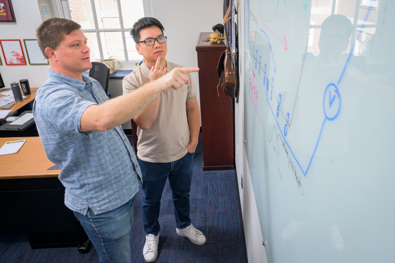 A new theoretical study led by University of Delaware engineers reveals that magnons, a type of magnetic spin wave, can produce detectable electric signals. Pictured, Matt Doty, professor in the Department of Materials Science and Engineering, and postdoctoral researcher D. Quang To discuss their findings. A new theoretical study led by University of Delaware engineers reveals that magnons, a type of magnetic spin wave, can produce detectable electric signals. Pictured, Matt Doty, professor in the Department of Materials Science and Engineering, and postdoctoral researcher D. Quang To discuss their findings.