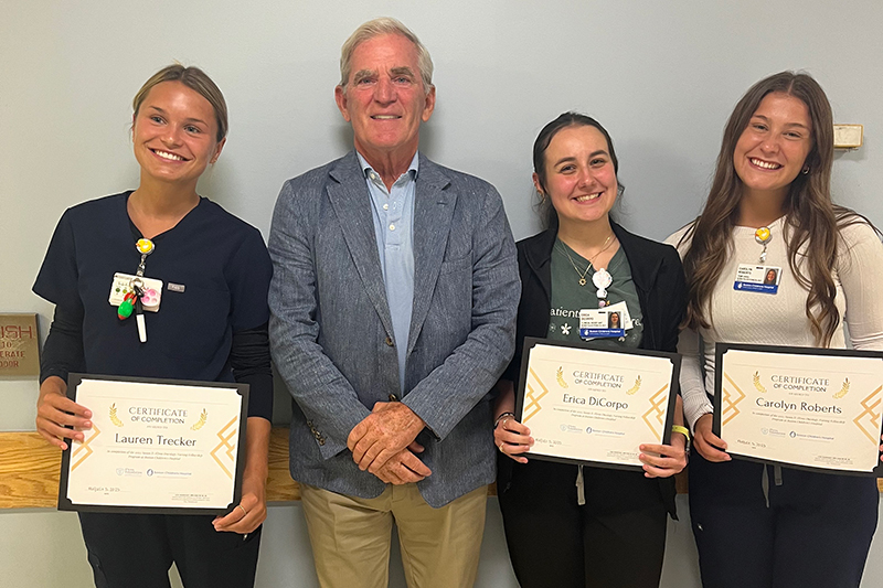 Erica Di Corpo (center), a senior nursing major, poses with Fred Flynn (center) of the Flynn Foundation, and other Flynn Fellows at the program’s graduation at Boston Children’s Hospital. Erica Di Corpo (center), a senior nursing major, poses with Fred Flynn (center) of the Flynn Foundation, and other Flynn Fellows at the program’s graduation at Boston Children’s Hospital.