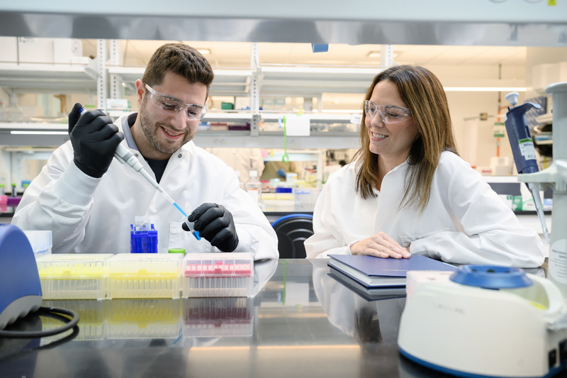 Eric Sterin, a recent UD biomedical engineering doctoral graduate, pipets a solution containing nanoparticles as professor Emily Day looks on. Eric Sterin, a recent UD biomedical engineering doctoral graduate, pipets a solution containing nanoparticles as professor Emily Day looks on.