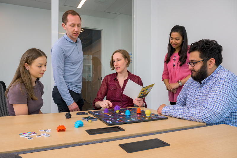 Professor Elise Corbin (center) works with her team on an educational board game to teach students complex biology concepts. The team includes, from left, doctoral students Colleen Simmerly, Connor Virgile, Afsara Tasnim and Ali Lateef. Professor Elise Corbin (center) works with her team on an educational board game to teach students complex biology concepts. The team includes, from left, doctoral students Colleen Simmerly, Connor Virgile, Afsara Tasnim and Ali Lateef.
