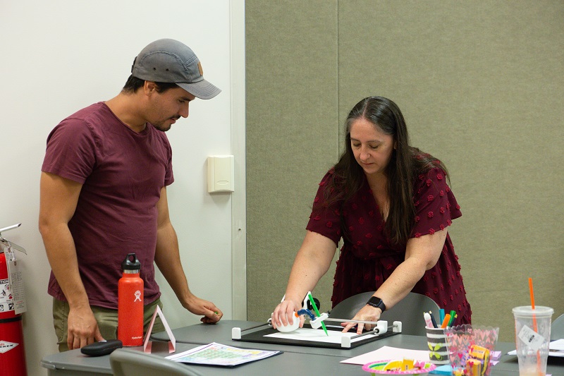 Visual and performing arts educators practice using assistive technology for the art classroom during Mennella and Wilt’s professional development session. 