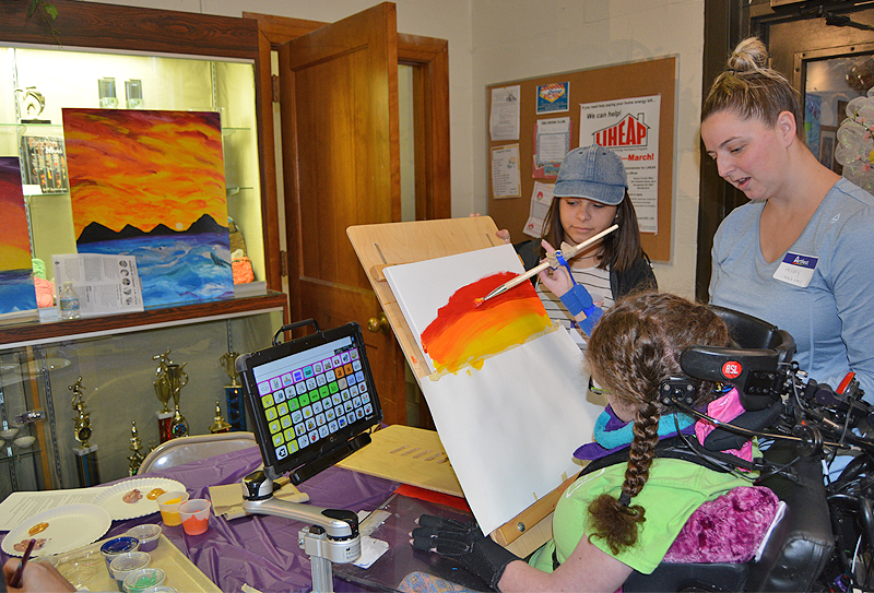 Students with disabilities often use adaptive devices to support their artistic work. Here, a student uses an adaptive tool during an ArtFest event. During the Center for Disabilities Studies’ training, visual and performing arts teachers learned how to support students with tools like this one and in other ways. 