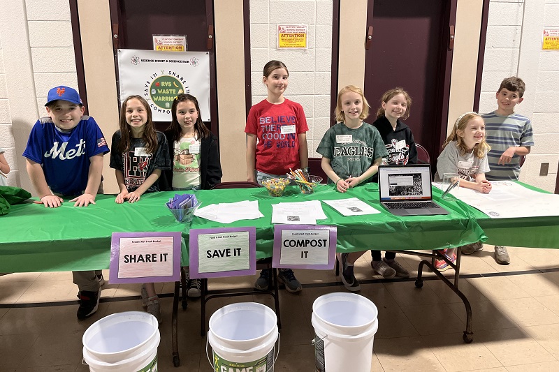 Elementary students participate in a food waste reduction campaign. 
