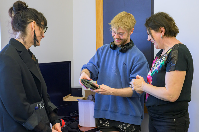 Graduate student Casey Tyler (center) took Gorea’s dress design and programmed it for the University’s state-of-the-art 3D knitting machine, eliminating the need for cutting and sewing while reducing waste and labor.