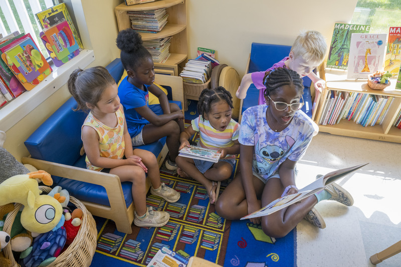 Youth guest readers enjoy books with preschoolers at the Early Learning Center.