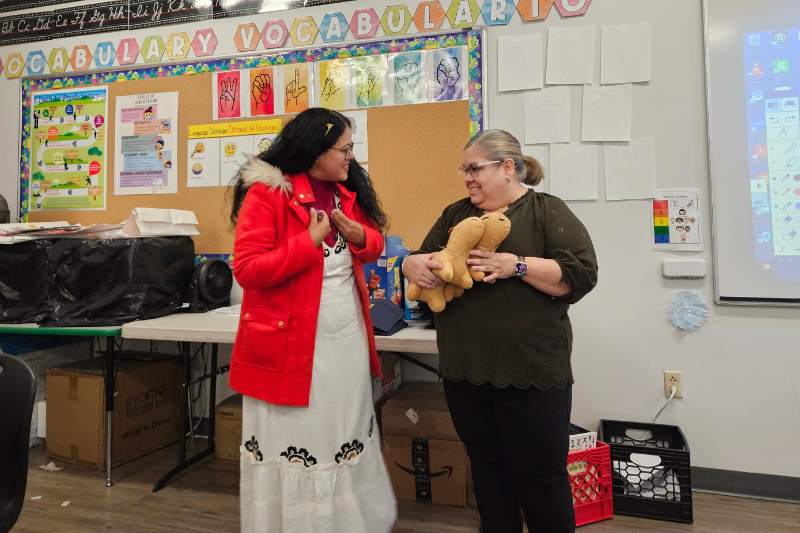 The group also met with teachers and classes at Newark's Las Américas ASPIRA Academy. Here, Loide Leite Aragão Pinto of Brazil (left), exchanges gifts with bilingual instructional coach Rosa Alicea.